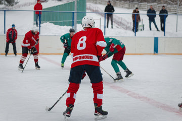 Ice hockey players in full gear competing hard on the ice during a game