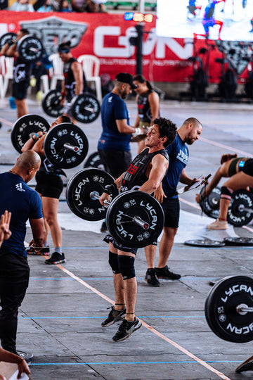 CrossFit athlete lifting weights during an intense competition workout