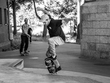 Skateboarder captured mid trick in a black and white action shot