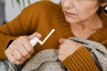 Nasal spray bottle next to nasal strips, comparing two approaches for nasal congestion relief and better sleep