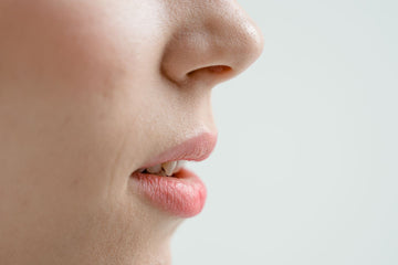 Close up side view of a woman's nose, showing the nostril flare where a nasal strip should sit