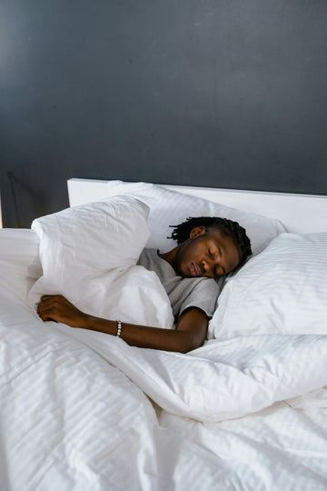 Man sleeping peacefully in bed, struggling with deviated septum breathing issues
