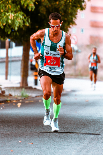 Runner wearing nasal strip and bib number during a race